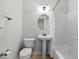 Clean bathroom featuring a pedestal sink, toilet, and a shower with a curtain at 504 21St Ave. N, North Myrtle Beach, SC 29582
