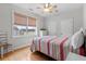 Bright bedroom features a striped bedspread, ceiling fan, and window with outside view at 504 21St Ave. N, North Myrtle Beach, SC 29582