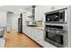 Modern kitchen featuring stainless steel appliances, granite countertops, and white cabinetry at 504 21St Ave. N, North Myrtle Beach, SC 29582