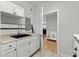 Functional laundry room with white cabinets, black sink, and doorway to another room at 504 21St Ave. N, North Myrtle Beach, SC 29582