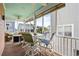 Inviting screened-in porch with a table, chairs, and views of neighboring homes at 504 21St Ave. N, North Myrtle Beach, SC 29582