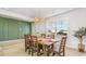 Dining room with a rustic wooden table and green accent wall at 515 Slaty Dr., Myrtle Beach, SC 29588