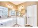 Bathroom boasts double sinks, granite countertops, and white cabinets at 5241 Casentino Ct., Myrtle Beach, SC 29579