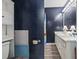 Bathroom with dual sink vanity, modern lighting, and stylish dark blue walls at 5508 Porcher Dr. # 4, Myrtle Beach, SC 29577