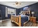 Cozy bedroom with wood-frame bed, a ceiling fan, and a view of the outside at 5508 Porcher Dr. # 4, Myrtle Beach, SC 29577