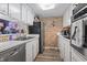 Kitchen featuring updated appliances, brick accent wall, and modern flooring at 5508 Porcher Dr. # 4, Myrtle Beach, SC 29577