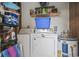 Utility closet featuring a washer, dryer, shelves, and hot water heater at 5508 Porcher Dr. # 4, Myrtle Beach, SC 29577
