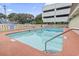 Community pool, surrounded by a fence and signs, offers a refreshing swim for residents at 5508 Porcher Dr. # 4, Myrtle Beach, SC 29577