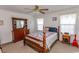 Cozy bedroom with a wooden bed frame, dresser, and ample natural light at 567 Woodholme Dr., Conway, SC 29526