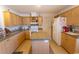 Light wood kitchen cabinets, granite countertops, and island at 567 Woodholme Dr., Conway, SC 29526