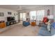 Bright living room with comfy seating, large TV, and access to a screened porch at 567 Woodholme Dr., Conway, SC 29526