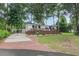 Park model home with deck, brick driveway, and landscaped lawn at 6001 - 8047 S Kings Hwy., Myrtle Beach, SC 29575