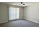 Bright bedroom with neutral walls and carpet, featuring a ceiling fan and window coverings at 608 Pipers Ln. # 608, Myrtle Beach, SC 29575