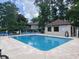 Community pool with surrounding lounge chairs and a pool house at 608 Pipers Ln. # 608, Myrtle Beach, SC 29575