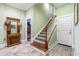 Inviting entryway with staircase, tile flooring, and coat rack at 8010 Wacobee Dr., Myrtle Beach, SC 29579