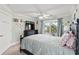 Bedroom with a ceiling fan and natural light from a balcony with sliding glass doors at 836 Crystal Water Way, Myrtle Beach, SC 29579