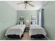 Bedroom with twin beds, a ceiling fan, and coastal decor at 895 Callant Dr., Little River, SC 29566