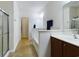 Bright bathroom with a walk-in shower, soaking tub with a half wall, and wood vanity at 900 British Ln. # 1187, Myrtle Beach, SC 29579