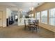 Bright dining area featuring a glass table, carpeted floors, and multiple windows at 900 British Ln. # 1187, Myrtle Beach, SC 29579