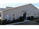 Attractive home exterior features neutral siding, manicured shrubs, and a sidewalk at 900 British Ln. # 1187, Myrtle Beach, SC 29579