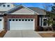 Attached home featuring a white garage door with a brick and siding exterior at 900 British Ln. # 1187, Myrtle Beach, SC 29579