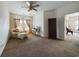 Spacious living room with a comfortable chair, decorative curtains, and a ceiling fan for added comfort at 900 British Ln. # 1187, Myrtle Beach, SC 29579