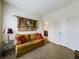 Comfortable living room with a golden couch, decorative tapestry on the wall, and an inviting lamp on the side table at 900 British Ln. # 1187, Myrtle Beach, SC 29579