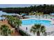 A resort-style swimming pool is surrounded by palm trees and offers a luxurious outdoor living space at 900 British Ln. # 1187, Myrtle Beach, SC 29579
