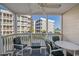 Screened balcony with seating and partial ocean view at 9570 Shore Dr. # 211, Myrtle Beach, SC 29572
