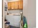 Small laundry room with washer, dryer, and cabinets at 9570 Shore Dr. # 211, Myrtle Beach, SC 29572