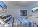 Bedroom with striped bedding, window, and dresser at 9571 Shore Dr. # 119, Myrtle Beach, SC 29572