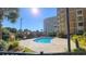 Relaxing resort-style pool with surrounding greenery at 9994 Beach Club Dr. # 506, Myrtle Beach, SC 29572