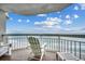 Serene balcony view showcasing comfortable seating and a breathtaking ocean scene at 1012 N Waccamaw Dr. # 902, Murrells Inlet, SC 29576