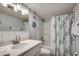 Bright bathroom featuring a stylish vanity and a shower with a decorative curtain at 1012 N Waccamaw Dr. # 902, Murrells Inlet, SC 29576