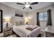 Cozy bedroom featuring a ceiling fan, painting, and a comfortable bed with bedside lamps at 1012 N Waccamaw Dr. # 902, Murrells Inlet, SC 29576