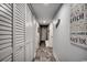 Hallway with white doors and trim, wood-look flooring, and nautical decorations on the wall at 1012 N Waccamaw Dr. # 902, Murrells Inlet, SC 29576