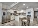 Modern kitchen with white cabinets, marble countertops and island with seating, and stainless steel appliances at 1012 N Waccamaw Dr. # 902, Murrells Inlet, SC 29576