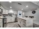 Modern kitchen with white cabinets, marble countertops and island, stainless steel appliances, and gray backsplash at 1012 N Waccamaw Dr. # 902, Murrells Inlet, SC 29576
