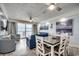 Bright living room with ocean view, comfortable seating, dining table, and large sliding glass door at 1012 N Waccamaw Dr. # 902, Murrells Inlet, SC 29576