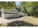 Spacious backyard featuring a well-maintained lawn and the back of the charming home with gray siding and refinished patio at 106 Governor Boone Ln., Georgetown, SC 29440