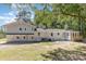 Expansive backyard with lush greenery, newly refinished patio, and the back side of the charming home at 106 Governor Boone Ln., Georgetown, SC 29440