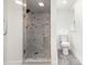 Modern bathroom featuring marble-tiled walk-in shower, updated fixtures, and wood-look flooring at 106 Governor Boone Ln., Georgetown, SC 29440