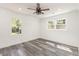 Bedroom showcasing gray wood-look floors, white walls, recessed lighting, and two windows at 106 Governor Boone Ln., Georgetown, SC 29440
