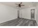 A spacious bedroom with wood-look flooring, a ceiling fan, and access to the bathroom and closet at 106 Governor Boone Ln., Georgetown, SC 29440