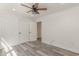 Bright bedroom features gray wood-look floors, white walls, and a modern ceiling fan at 106 Governor Boone Ln., Georgetown, SC 29440
