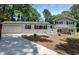 Charming updated two-story home featuring a grey and white painted brick facade, well-kept lawn, and attached garage at 106 Governor Boone Ln., Georgetown, SC 29440