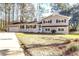 Charming two-story home with a well-manicured lawn, painted brick facade, an attached garage, and mature trees at 106 Governor Boone Ln., Georgetown, SC 29440