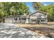 Newly renovated gray house with white brick accents, long driveway and landscaping at 106 Governor Boone Ln., Georgetown, SC 29440