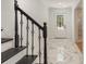 Stunning foyer featuring marble floors, decorative stair railing, and a view to the front door entrance at 106 Governor Boone Ln., Georgetown, SC 29440