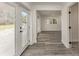 Hallway with wood-look flooring and access to bright, well-lit rooms, each with its own door at 106 Governor Boone Ln., Georgetown, SC 29440